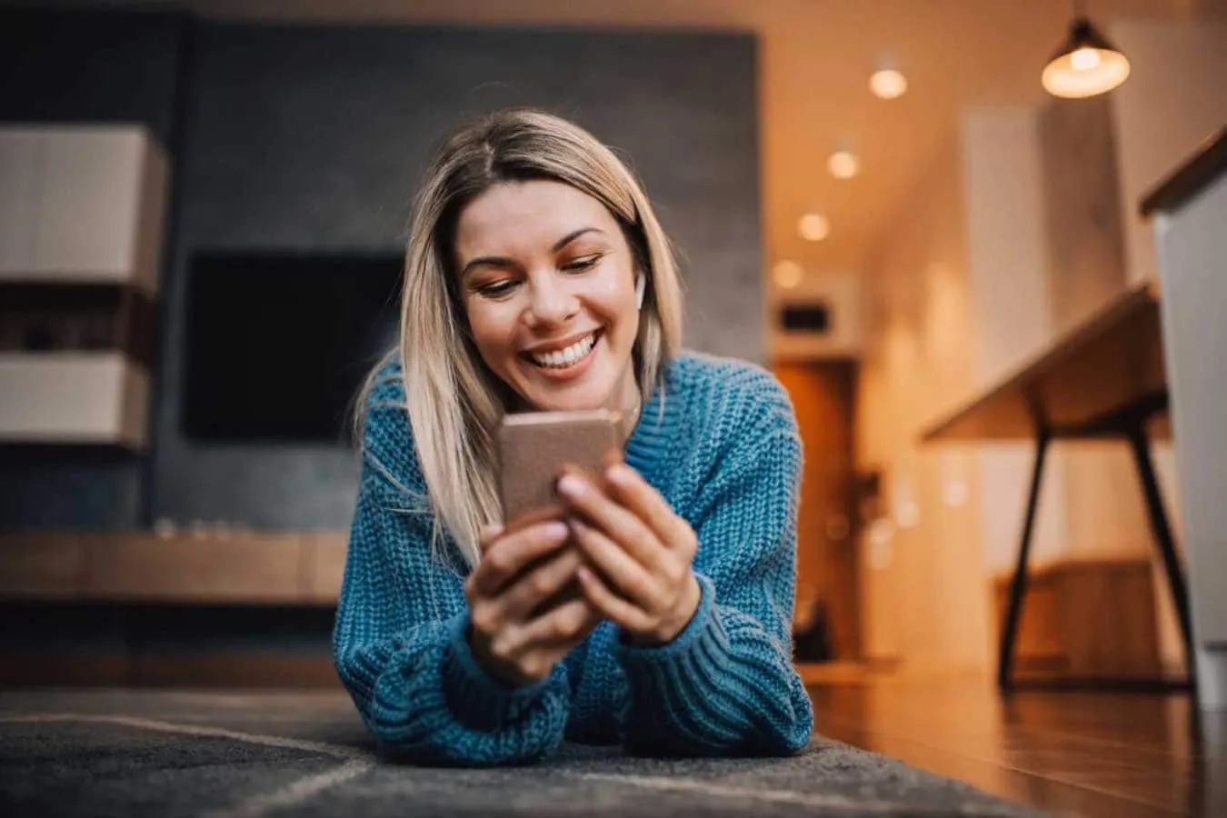 happy-woman-lying-floor-home-surfing-internet-phone-1
